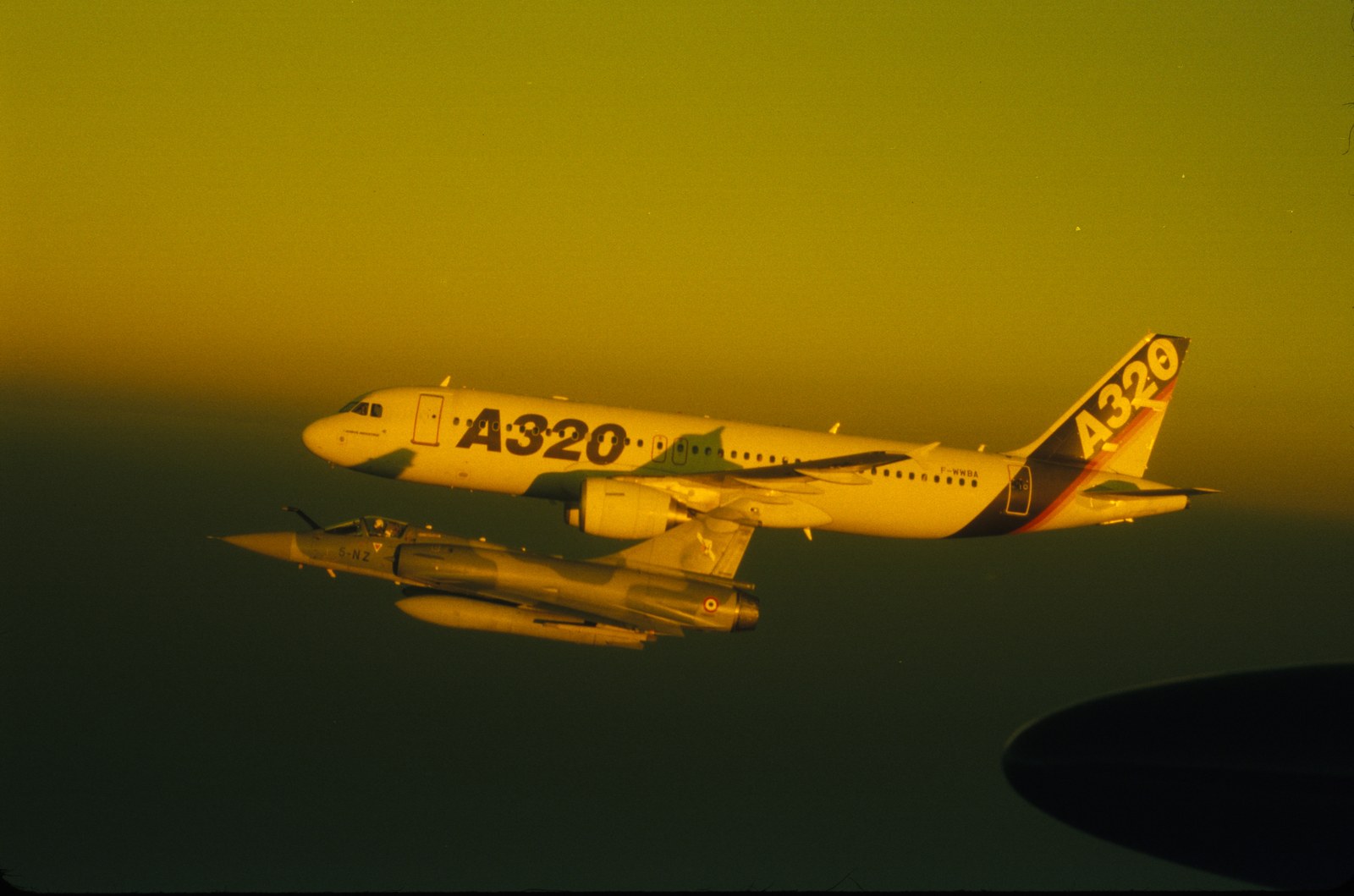 Airbus A320 flying in tight formation with French Mirage fighter jet